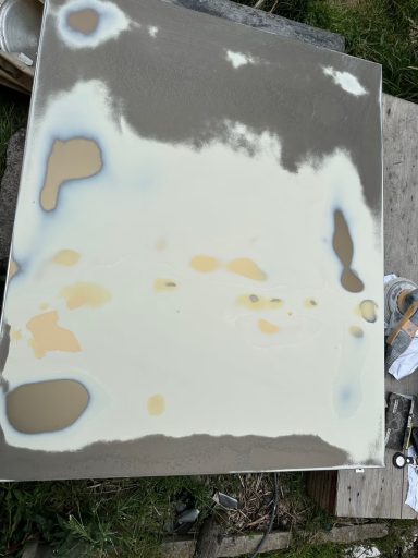 Damaged Sheffield University Panels : Before A surface with uneven patches of beige and light blue paint on a grey background.